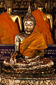 Bangkok Wat Pho, the southern wihan, one of the four side chapels around the ubosot. Disciples seated in front the Buddha statue called Buddha Chinnaraja. 